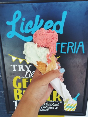 green apple and strawberry sherbet on a cone