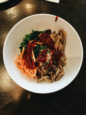 rice topped with different vegetables, and herbs to be mixed with chili paste