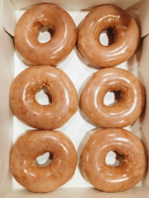 freshly glazed golden doughnuts