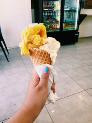 generous scoops of mango and lemonade sherbet ice cream in a cone