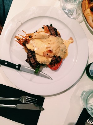 a surf (jumbo prawns) and turf (beef fillet) main meal